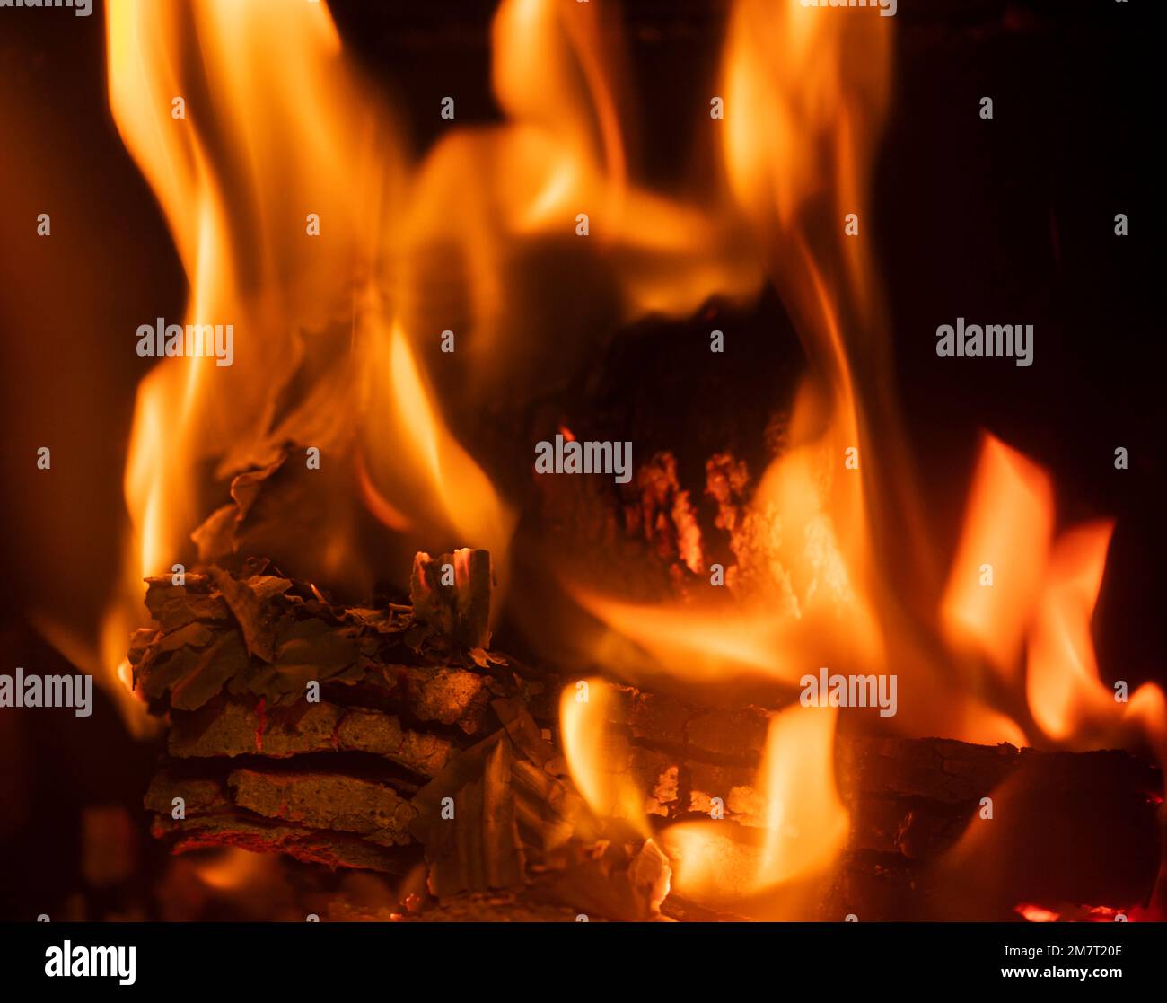 Irish peat briquettes burning inside wood burner Stock Photo Alamy