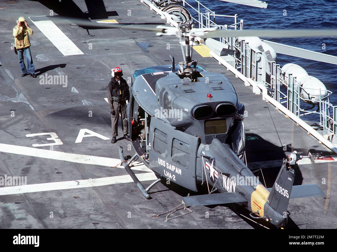 A flight deck crewman aboard the amphibious assault ship USS SAIPAN ...