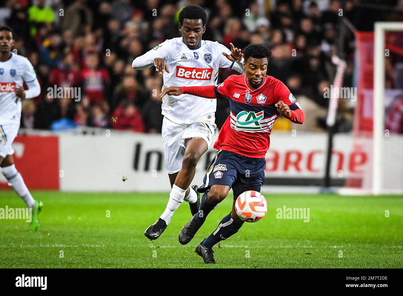 Derek MAZOU-SACKO of Troyes and Angel GOMES of Lille during the French Cup, round of 64 football match between LOSC Lille and ESTAC Troyes on January 8, 2023 at Pierre Mauroy stadium in Villeneuve-d'Ascq, France - Photo: Matthieu Mirville/DPPI/LiveMedia Stock Photo