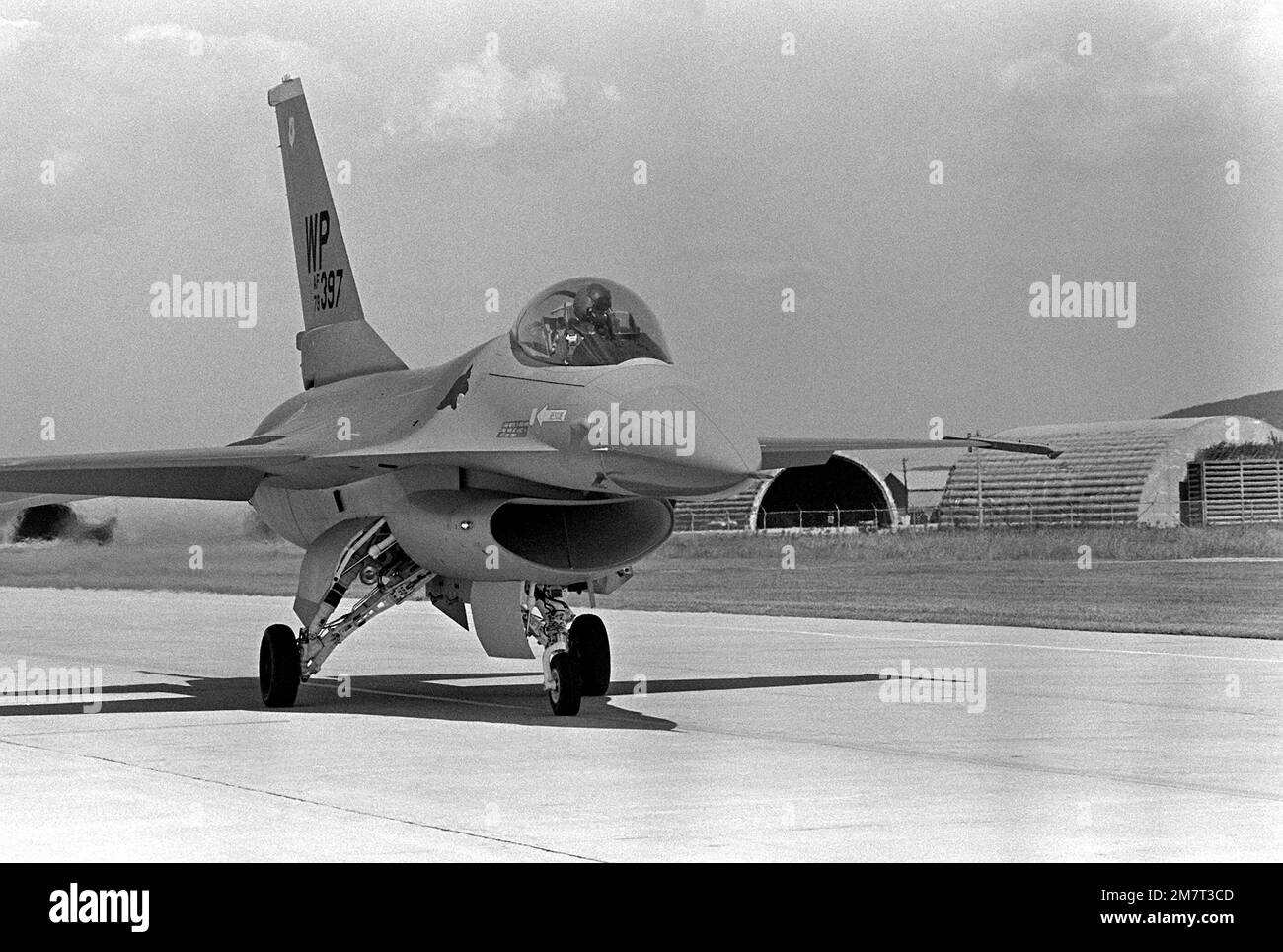 A right front view of an F16 Fighting Falcon aircraft taxiing to the runway apron upon its