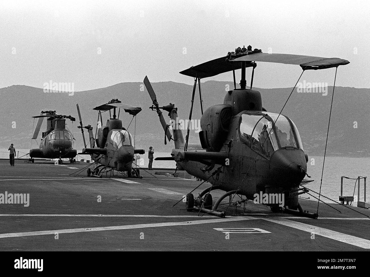 Two AH-1 Sea Cobra and a CH-46 Sea Knight helicopter are secured on the deck of the amphibious ship USS SAIPAN (LHA-2) during NATO exercise Display Determination '81. Subject Operation/Series: DISPLAY DETERMINATION '81 Country: Mediterranean Sea (MED) Stock Photo