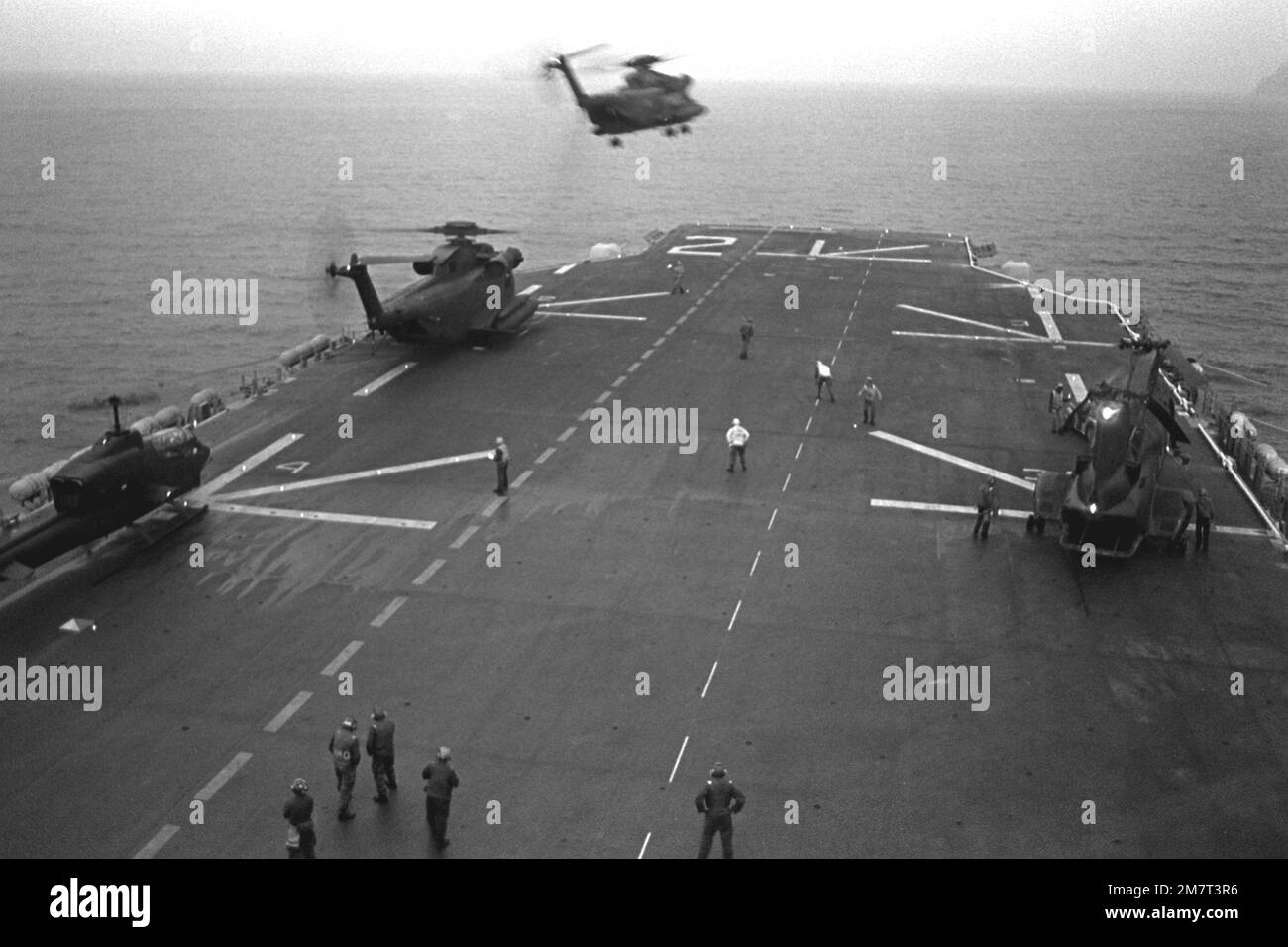An H-53 Sea Stallion helicopter lifts off the flight deck of the amphibious assault ship USS SAIPAN (LHA-2) during the NATO exercise Display Determination '81. The other helicopters are from left to right: an AH-1 Sea Cobra, an H-53 Sea Stallion and an H-46 Sea Knight. Subject Operation/Series: DISPLAY DETERMINATION '81 Country: Mediterranean Sea (MED) Stock Photo
