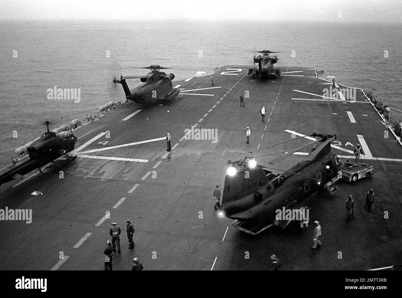 A view of helicopters on the deck of the amphibious assault ship USS SAIPAN (LHA-2).The helicopters are, starting at left: an AH-1 Sea Cobra, two H-53 Sea Stallion and an H-46 Sea Knight. The ship and helicopters are involved in a NATO exercise Display Determination '81. Subject Operation/Series: DISPLAY DETERMINATION '81 Country: Mediterranean Sea (MED) Stock Photo