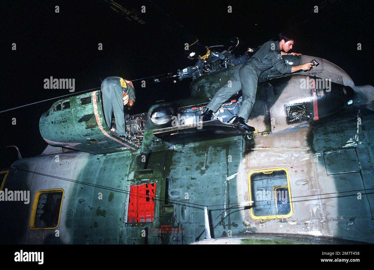 SSGT Carlton Johnson performs pre-flight maintenance on an HH-3 Jolly Green Giant helicopter, for use in Aerospace Rescue and Recovery Squadron (ARRS) operations of the DATU KALANTIAW, a Philippine destroyer escort ship which capsized on Cayalan Island. Base: Clark Air Base State: Luzon Country: Philippines (PHL) Stock Photo