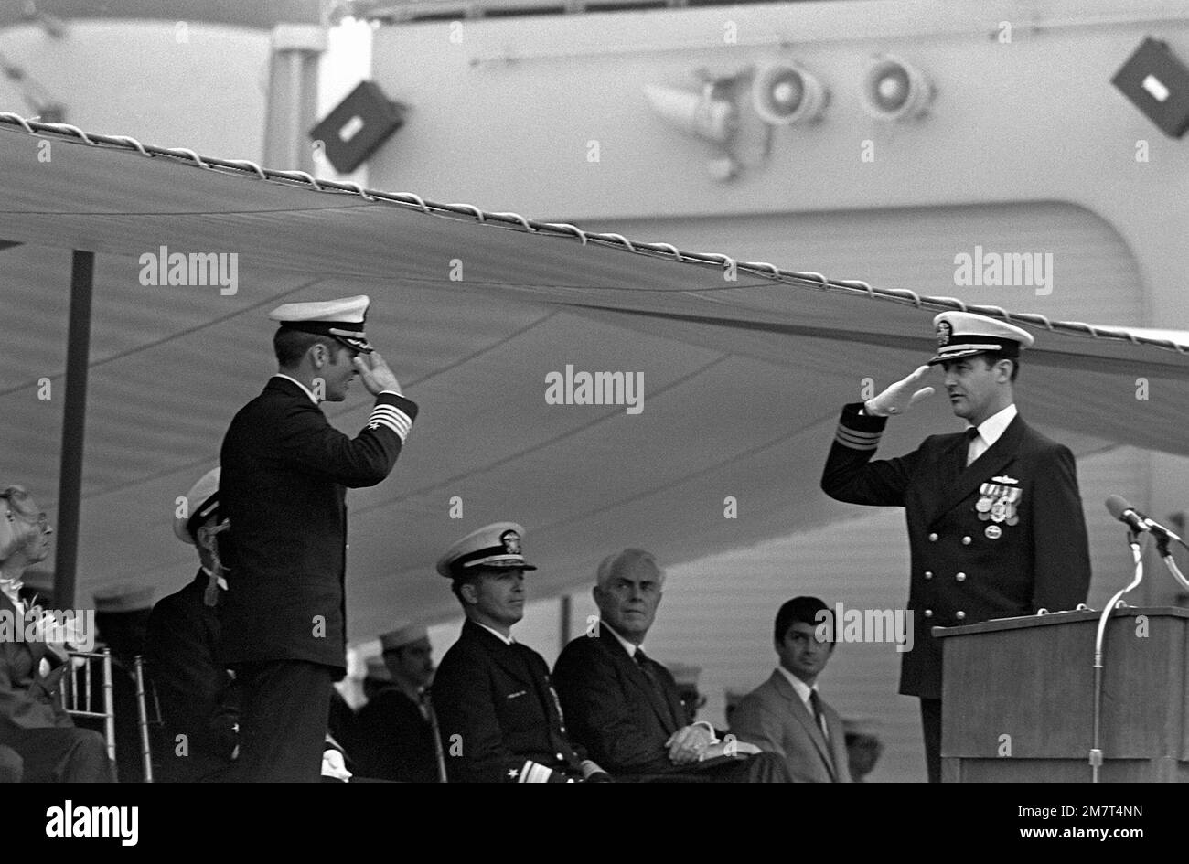 CAPT Stephen J. Duich, left, chief staff officer to Commander Destroyer Squadron Eight (DESRON-8), and CMDR William H. Wright IV, commanding officer, salute while on the speakers platform at the commissioning of the guided missile frigate USS ANTRIM (FFG-20). Base: Seattle State: Washington (WA) Country: United States Of America (USA) Stock Photo