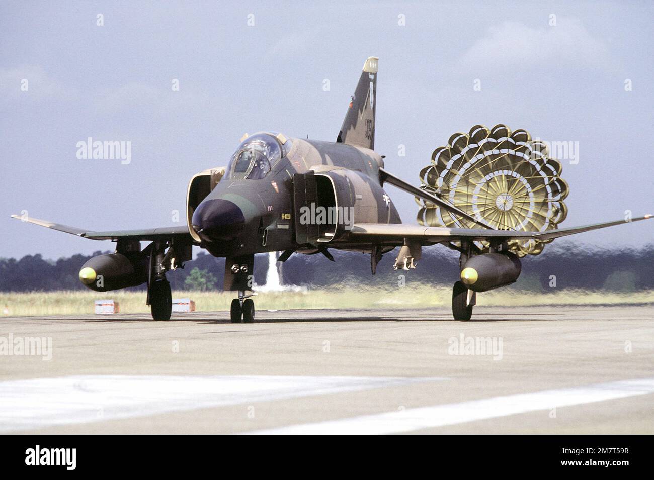 The drag chute opens on the tail of an F-4E Phantom II aircraft upon landing during exercise PHOTO Finish '81. Subject Operation/Series: PHOTO FINISH '81 Base: Gulfport State: Mississippi (MS) Country: United States Of America (USA) Stock Photo