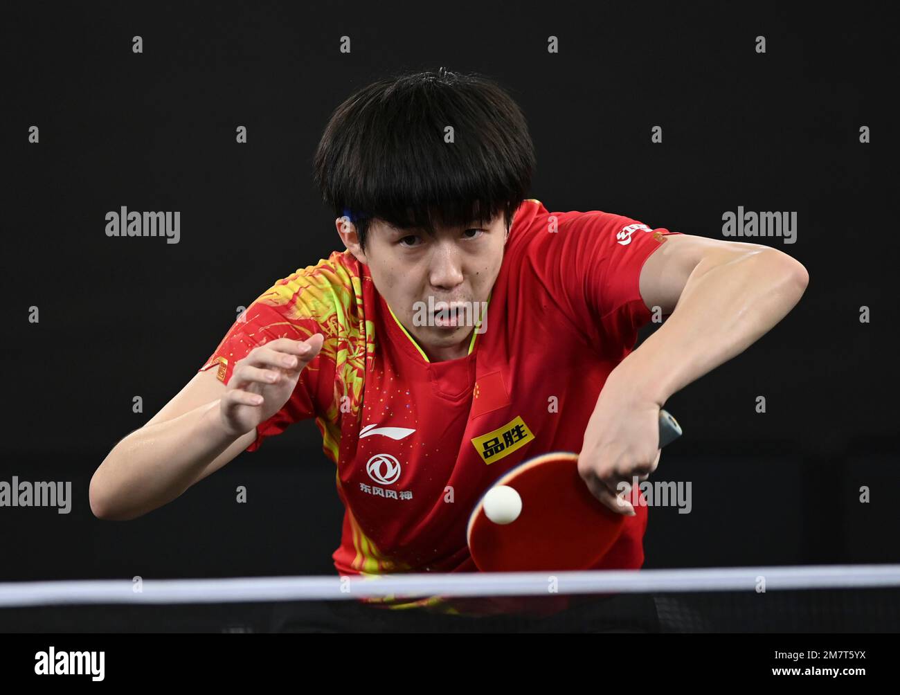 Doha, Qatar. 10th Jan, 2023. Wang Chuqin of China hits a return during the  men's singles round of 32 match against Noshad Alamiyan of Iran at World Table  Tennis Championships (WTTC) Asian
