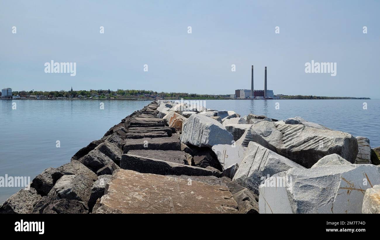 A breakwater stretches out into the Oswego Harbor and along the shoreline of Lake Ontario in Oswego, New York, May 12, 2022. The breakwater, which is maintained by the Buffalo District, ensures safe navigation for commercial and recreational vessels travelling on the Great Lakes and the Oswego River. Stock Photo