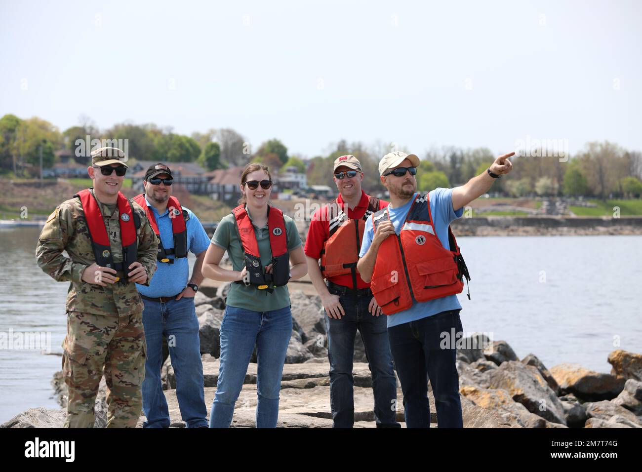 U.S. Army Corps of Engineers, Buffalo District team members stand on the Oswego Harbor breakwater off the coast of Oswego, New York, May 12, 2022. The breakwater, which is maintained by the Buffalo District, ensures safe navigation for commercial and recreational vessels travelling on the Great Lakes and the Oswego River. Stock Photo