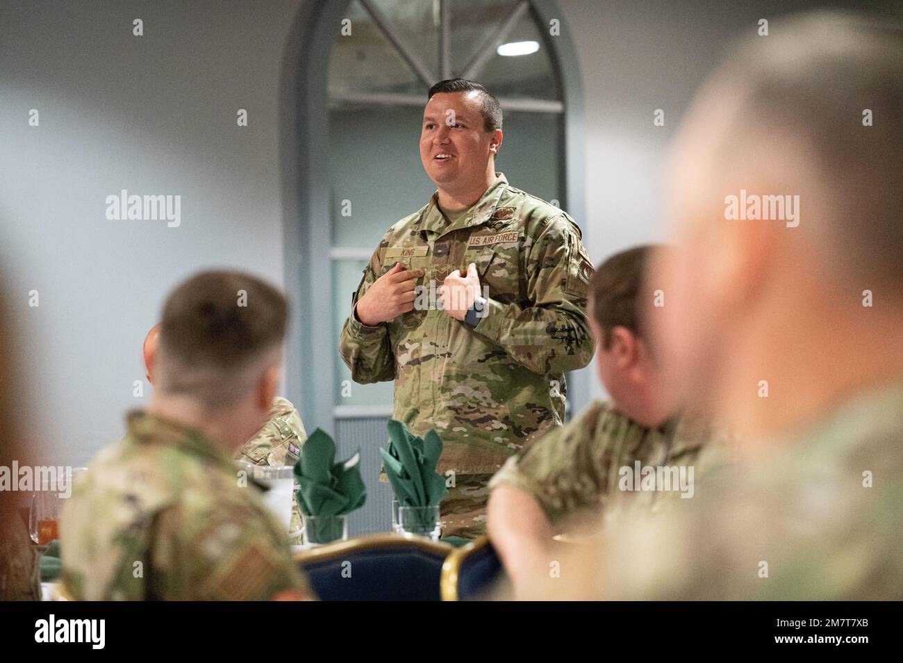 U.S. Air Force Tech Sgt. Howard King, 48th Operational Support Squadron Aircrew Flight Equipment noncommissioned officer in charge, introduces himself during an NCO luncheon at Royal Air Force Lakenheath, England, May 12, 2022. The Liberty Wing places a strong emphasis on strengthening interoperability with allies and partners. Stock Photo