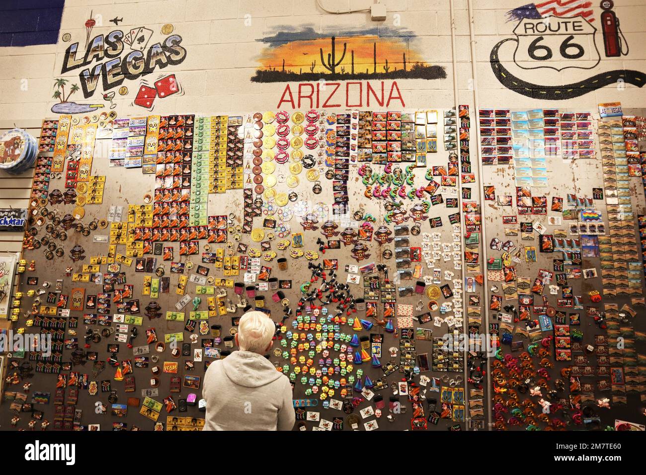 Senior woman at a souvenir shop in Arizona. Colorful and different shape fridge magnets. Stock Photo