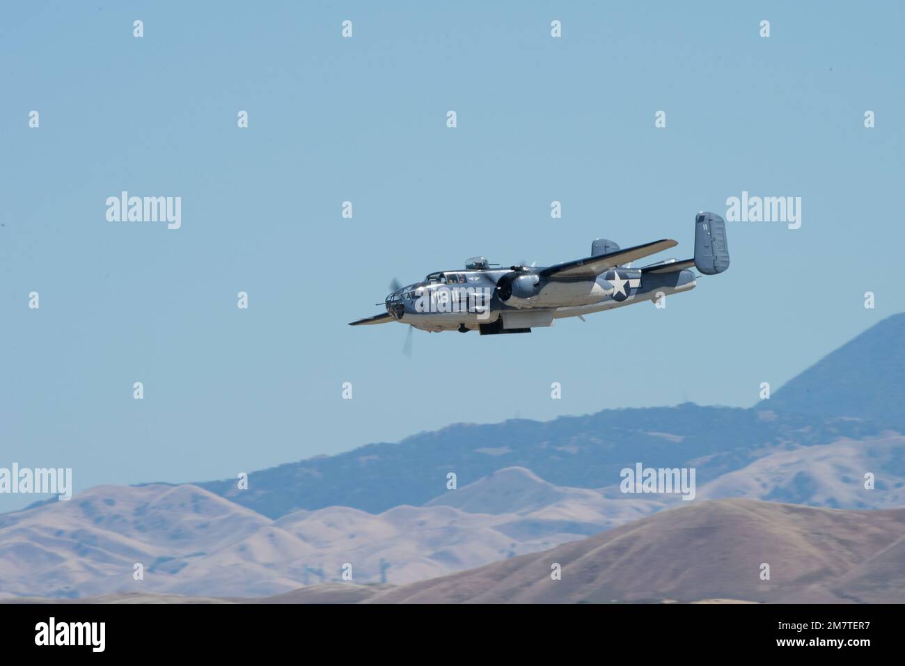 A Mitchell B-25 bomber performs a fly-by during the air show rehearsal at Travis Air Force Base, California, May 13, 2022. The air show rehearsal provided an opportunity for Department of Defense employees and their families to see the air show and full display of the capabilities at Travis AFB. Stock Photo