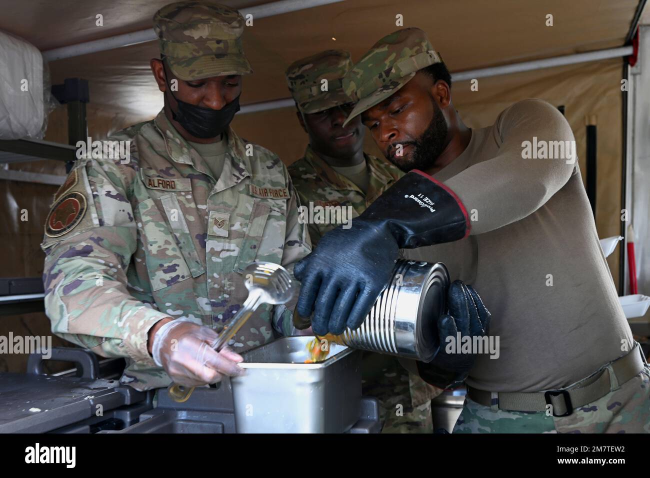 U.S. Air Force Staff Sgt. Damarcus Alford, food service supervisor (left) and Senior Airman Andre Price, store room apprentice, with the 169th Force Support Squadron prepare food in the Single Pallet Expeditionary Kitchen (SPEK) during the May Regularly Scheduled Drill at McEntire Joint National Guard Base, South Carolina, May 13, 2022. The purpose of the SPEK exercise is to provide valuable training to the 169FSS Airmen while utilizing the mobile kitchen that can be operated in a deployed environment. U.S. Air Force photo by Capt. Stephen Hudson, 169 Fighter Wing Public Affairs). Stock Photo