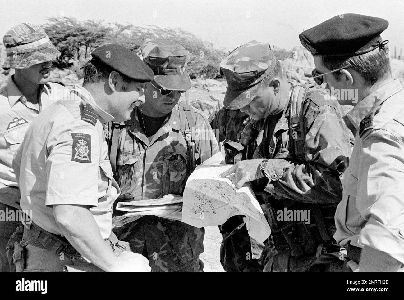 During a briefing U.S. Marine CPT Allan Bacon uses a terrain map to