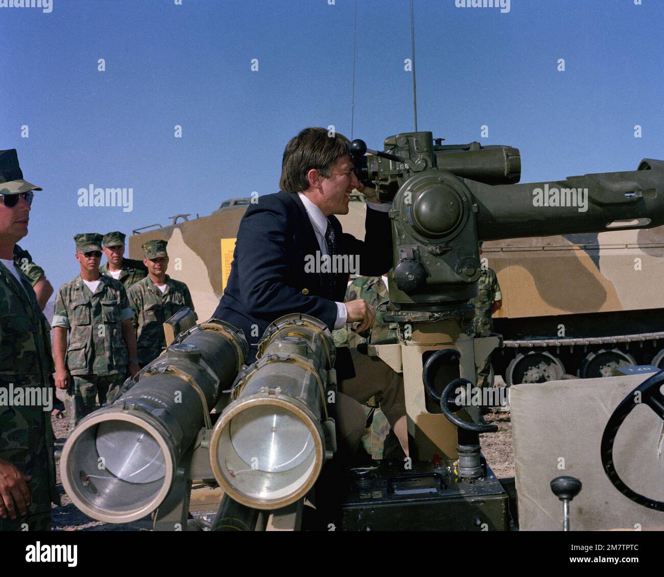 Secretary of the Navy John Lehman Jr. gets a chance to look through the sights of a heavy anti-tank weapon (TOW) during his tour of military installations. These Marines are participating in a CAX operation at the Marine Corps Air-Ground Combat Center. Base: Twentynine Palms State: California (CA) Country: United States Of America (USA) Stock Photo