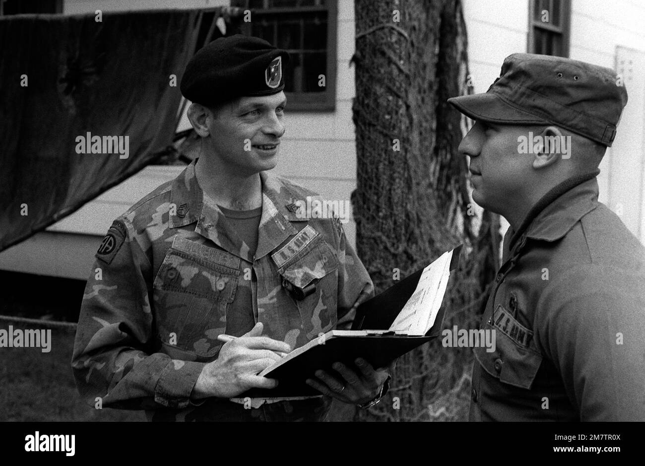 SSGT Ronald Klumeper, non-commissioned officer in charge, Ranger Indoctrination Program (RIP), counsels PFC James Lee, 2nd Battalion, 75th Infantry (Ranger), on upcoming training. Base: Fort Lewis State: Washington (WA) Country: United States Of America (USA) Stock Photo