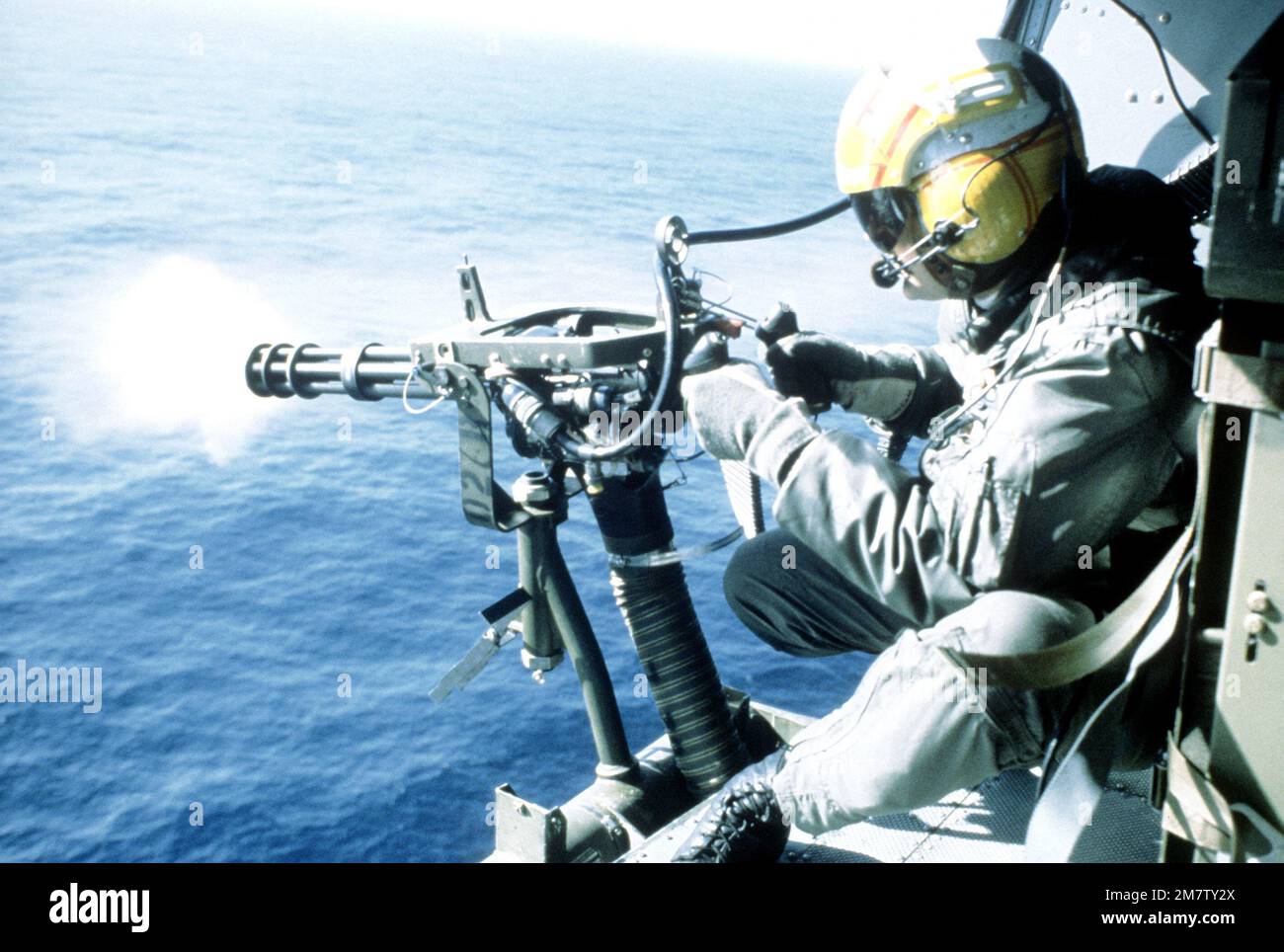 A member of the 2nd Marine Aircraft Wing fires a gas operated gatling gun from an aircraft during Operation Alloy Express '82. Subject Operation/Series: ALLOY EXPRESS '82 Country: Norway (NOR) Stock Photo