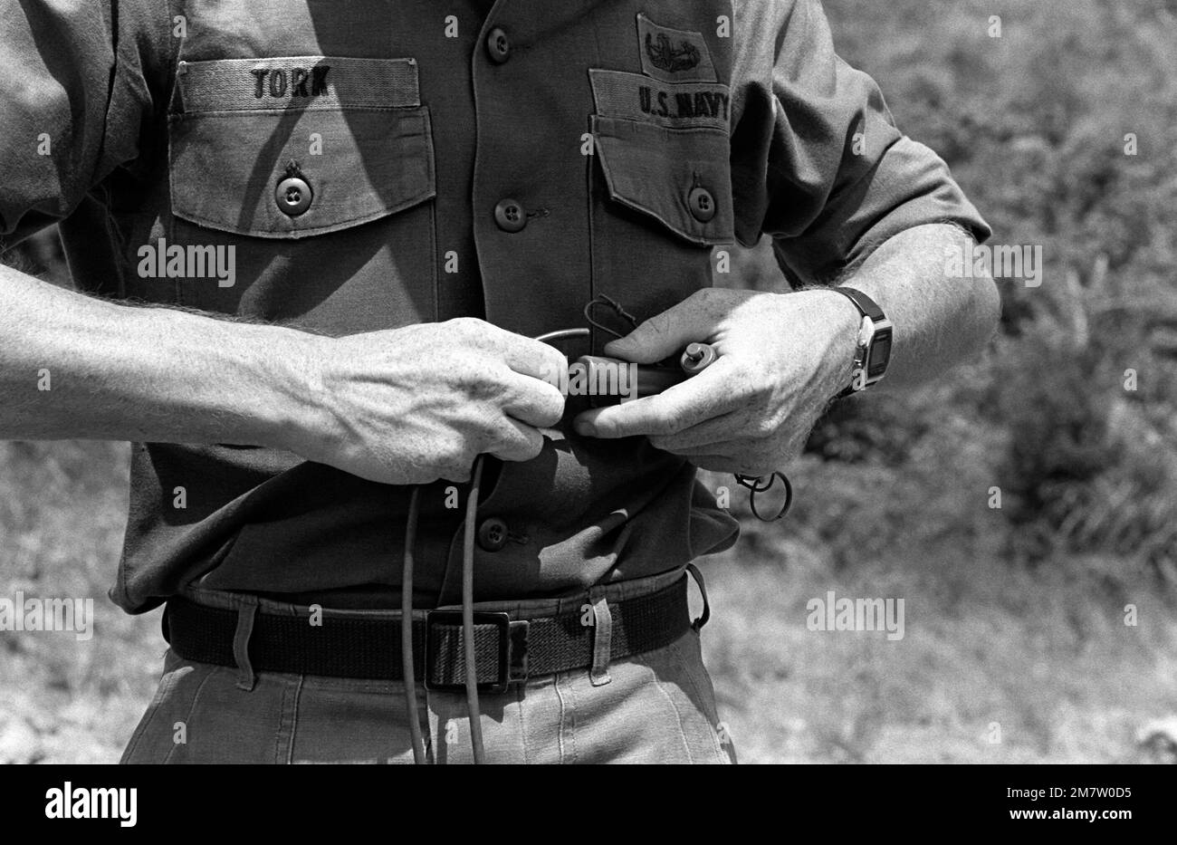 A member of a US Navy Explosive Ordnance Disposal unit attaches a cable