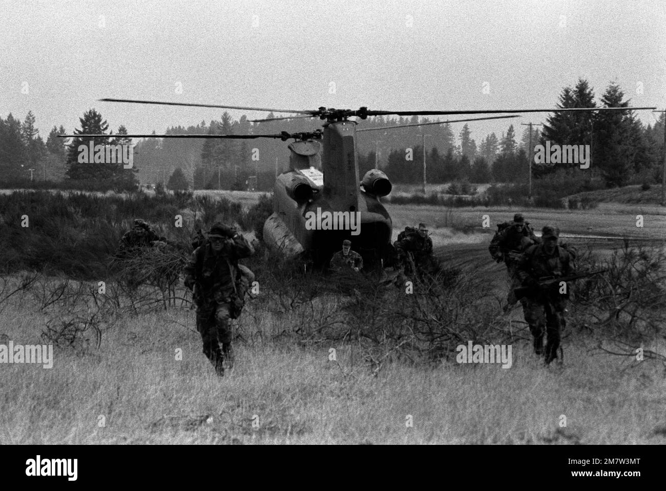 Members of the 9th Infantry Scout Company spread out after exiting a CH-47 Chinook helicopter during an exercise at Range 9. Base: Fort Lewis State: Washington (WA) Country: United States Of America (USA) Stock Photo