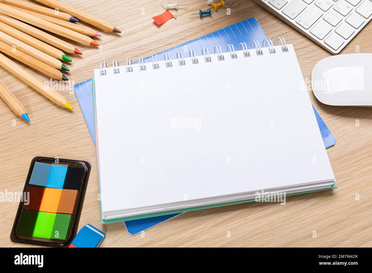 Back to school concept. Top view photo of notepads, pens, sharpeners, ruler, staplers, clips, markers and erasers on wooden table Stock Photo