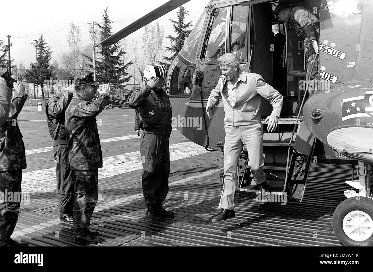 Staser VADM M. Staser Holcomb, commander, 7th Fleet, is saluted by other ...
