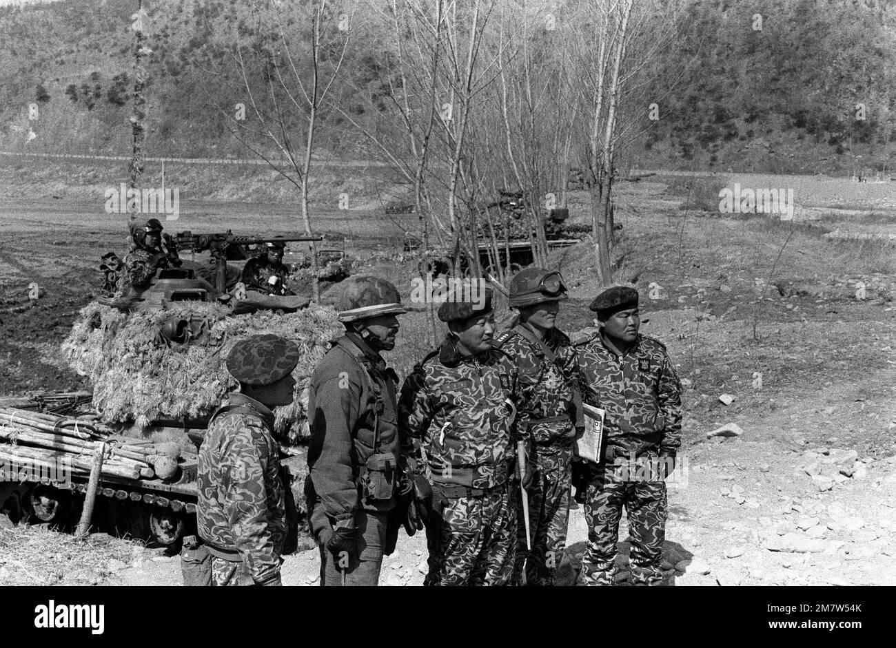 LCOL Michael J. Sierra, commander, 1ST Bn., 35th Inf., 25th Infantry Div., second from the left, looks over the Combat Outpost Line in the Cheop Yeong Valley with members of the South Korean Army 2nd Tank Battalion during the joint South Korea/U.S. training exercise Team Spirit '82. Subject Operation/Series: TEAM SPIRIT '82 Base: Cheop Yeong Country: Republic Of Korea (KOR) Stock Photo