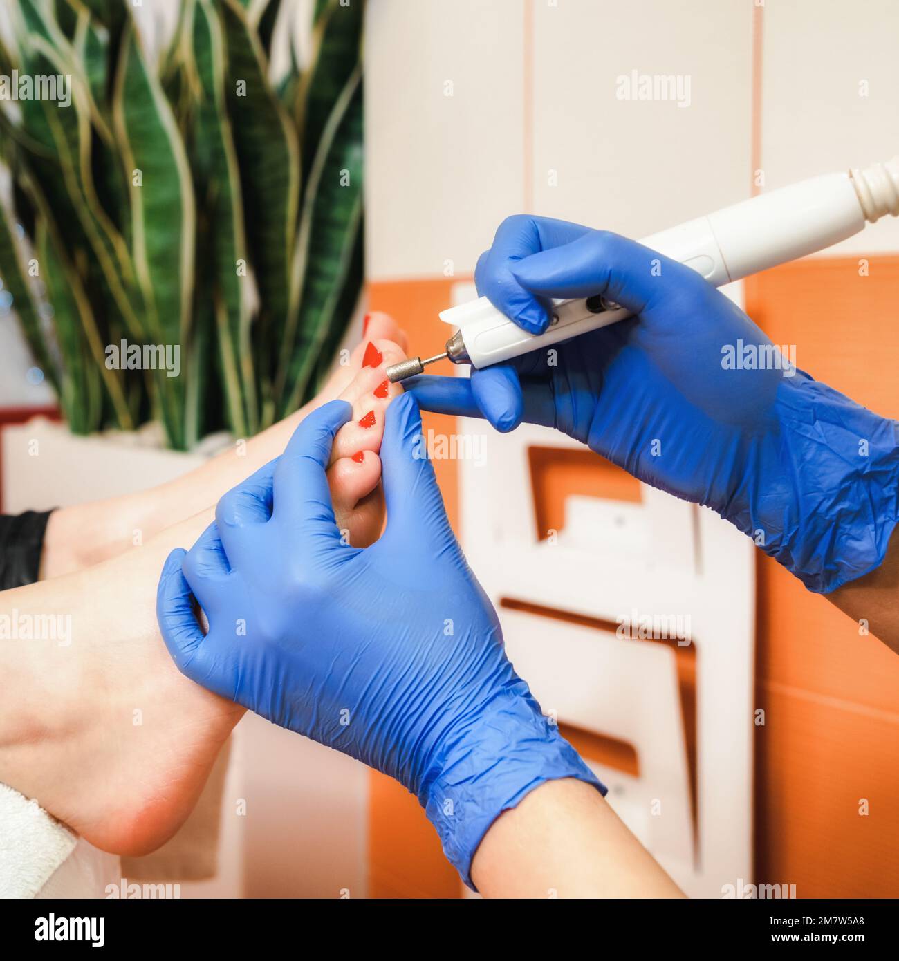 Feet being treated by professional pedicure specialist, chiropodist