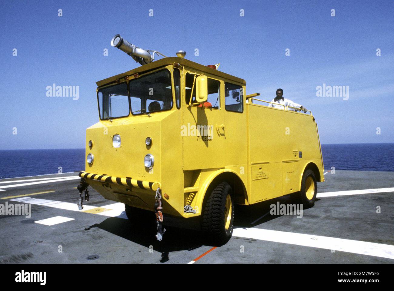 A fire truck rolls across the deck of the amphibious assault ship USS ...