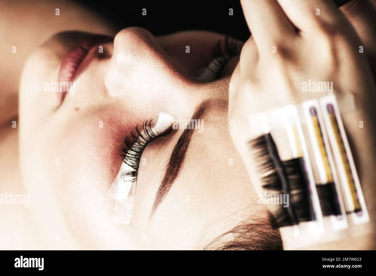 Eyelash Extension Procedure. Woman Eye with Long Eyelashes. Lashes, close up. Stock Photo