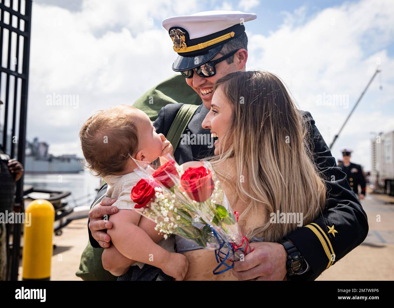 Lt. j.g. Mark Driver, assigned to the Los Angeles-class fast-attack submarine USS Albany (SSN 753), embraces his wife, Maya, and son, Kellen, during the boat’s homecoming to Naval Station Norfolk, May 14, 2022. Albany returned following a six-month deployment that supported national security interests and maritime security operations at sea. Stock Photo