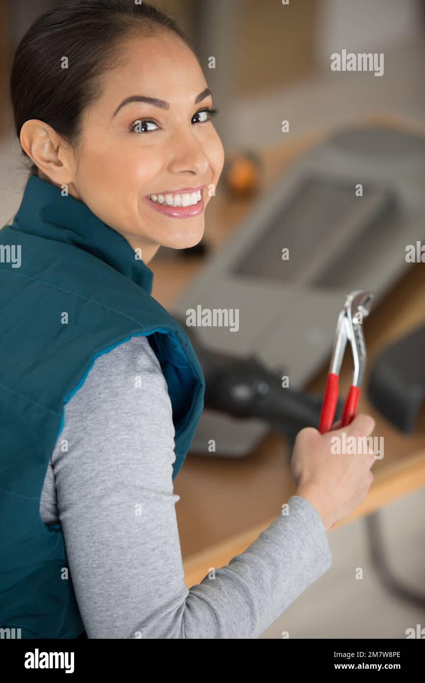 woman with tools smiling at camera Stock Photo