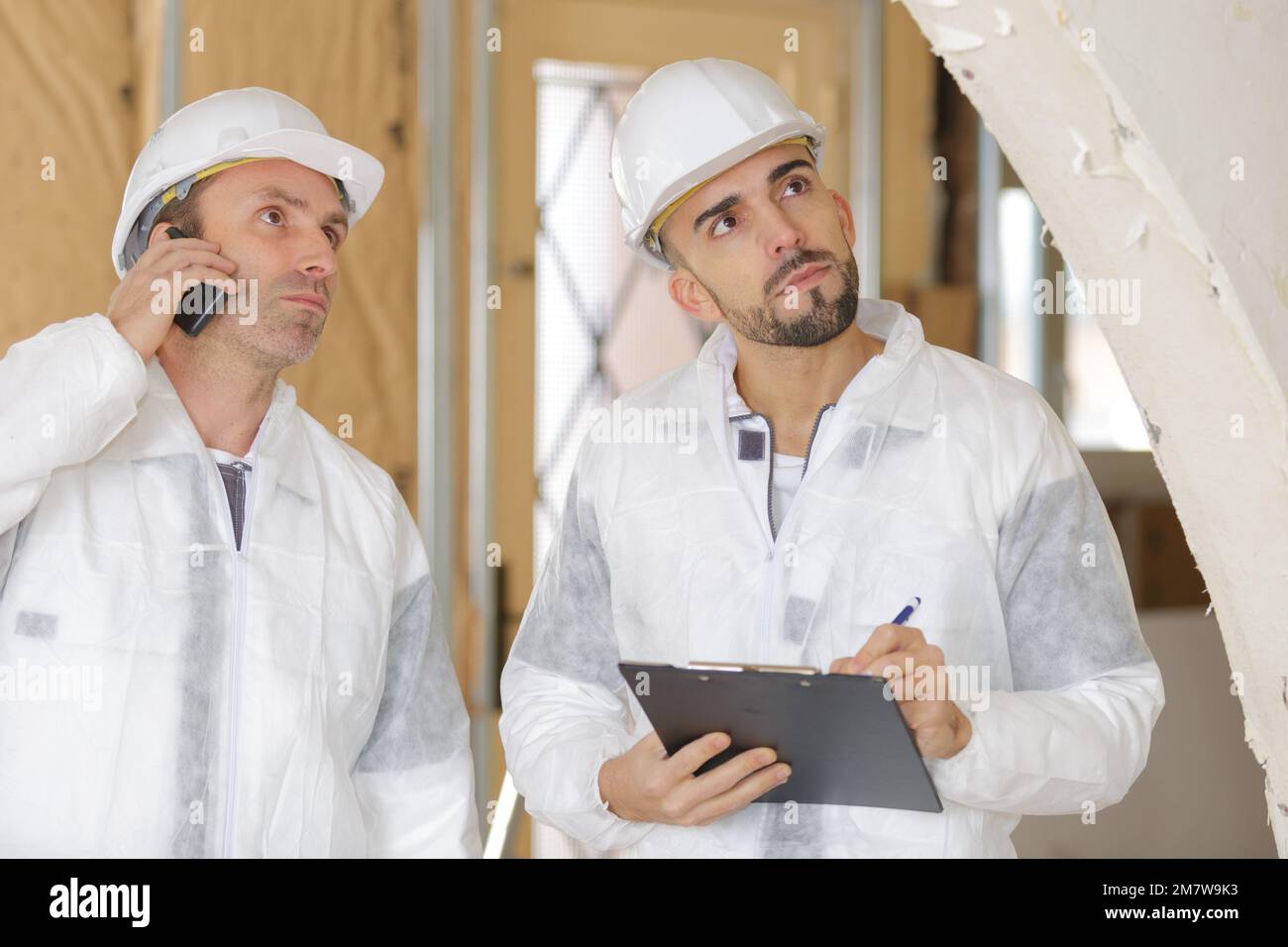Men in hardhats inspecting site Stock Photo