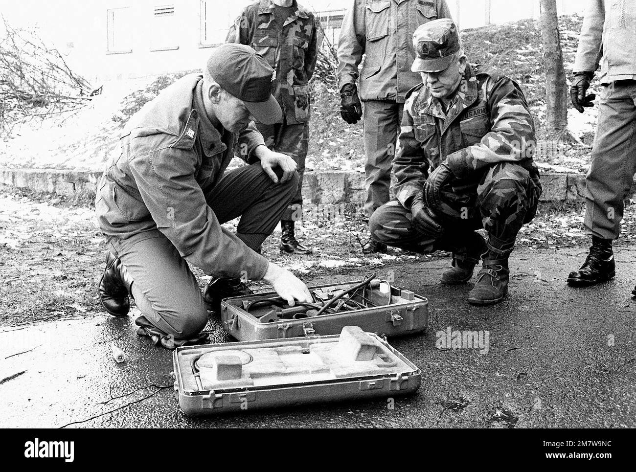 SGM of the Army William A. Connelly listens, as SPC Delta from the 54th Engineering Squadron explains the setting up of a mine detector. Base: Wildflecken Country: West Germany (FRG) Stock Photo