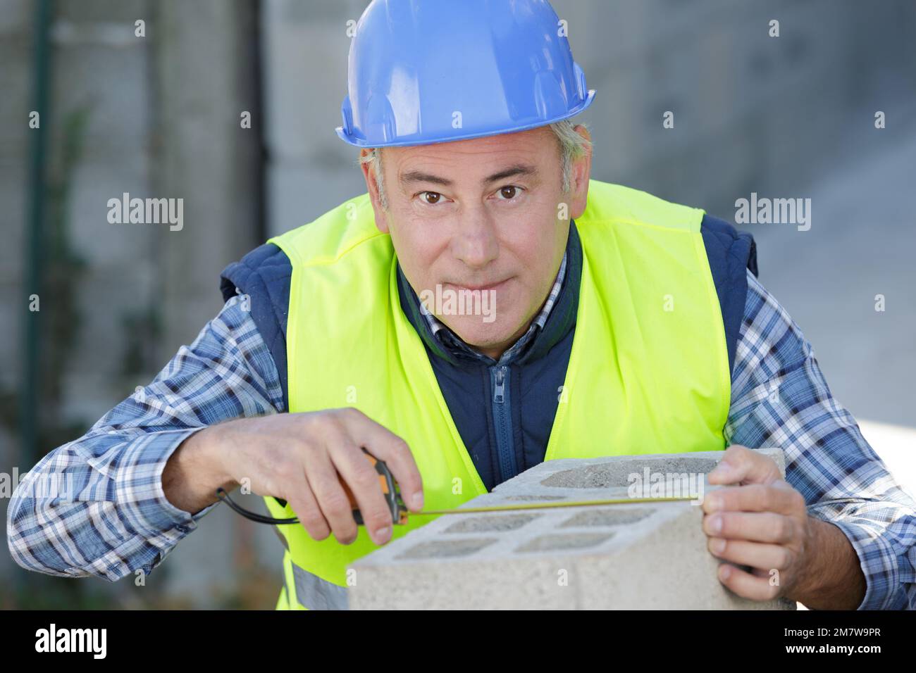 man bricklayer is working with brick block cement Stock Photo Alamy