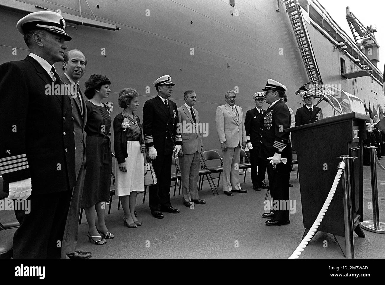 CAPT. Robert F. Baril, in front of the podium commanding officer, faces other guests of honor at the commissioning ceremony for the destroyer tender USS CAPE COD (AD-43). Left to right are: CAPT. Ecker, Chaplain; Sen. Doane, Mass.; Victoria Ann Murray, maid of honor; Betty Evan Murray, sponsor; Vice Adm. Lee Baggett Jr.; Robert J. Murray, principal speaker; Larry French, president, National Steel and Shipbuilding Co.; and CAPT. Martin Hill, supervisor of shipbuilding. Base: San Diego State: California (CA) Country: United States Of America (USA) Stock Photo