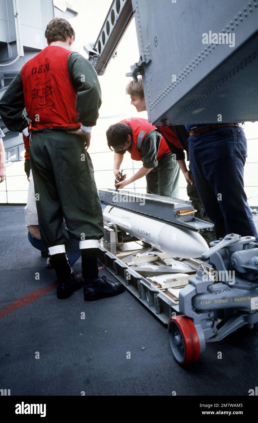 Ordnancemen load Sea Sparrow (RIM-7) missile into a box launcher aboard the nuclear-powered aircraft carrier USS CARL VINSON (CVN 70). Country: Unknown Stock Photo