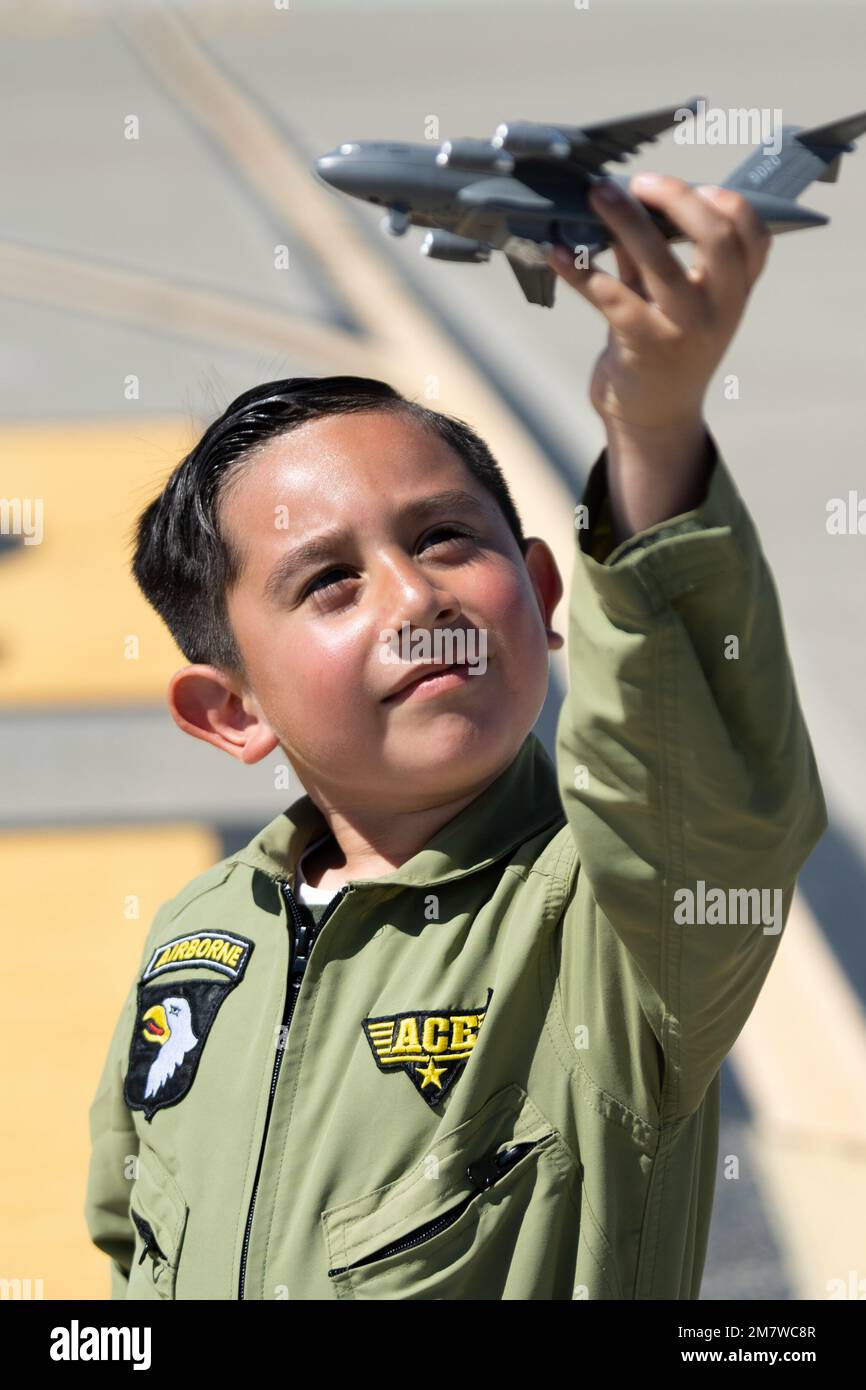 A child plays with a toy airplane during Wings Over Solano at Travis Air  Force Base, California, May 14, 2022. The Wings Over Solano open house and air  show provided an opportunity