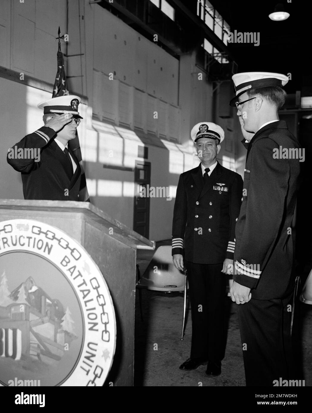 LT. j. g. Bill Galloway, left, is relieved as commanding officer of Construction Battalion Unit 417 by LT. MAC Thigpen, at right. Country: Unknown Stock Photo