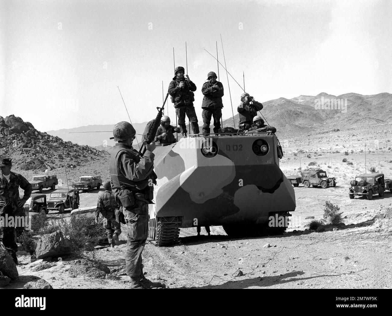 Marines going through training at the Marine Corps Air-Ground Combat Center stand by as they wait for a visit from the touring Secretary of the Navy John Lehman Jr. Base: Twentynine Palms State: California (CA) Country: United States Of America (USA) Stock Photo