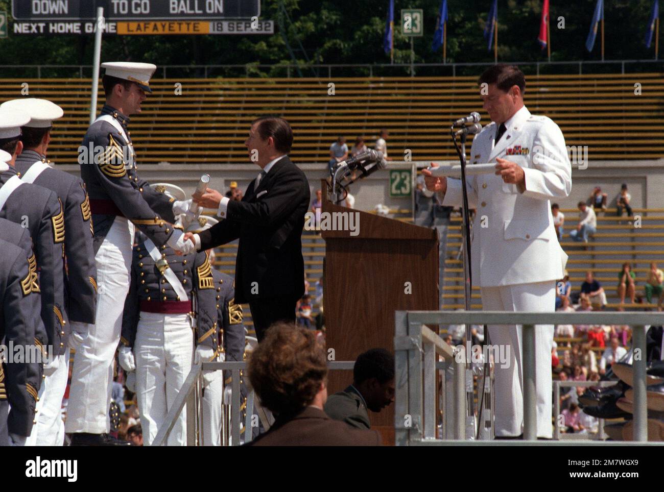 A cadet receives his diploma from Sen. John Tower, RTexas, during