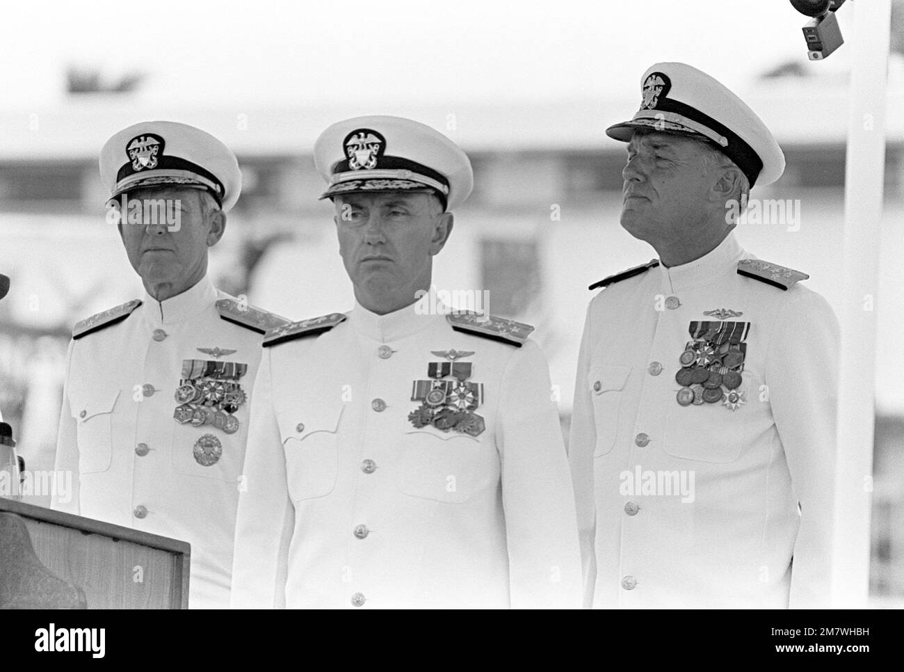 CHIEF of Naval Operations ADM Thomas B. Hayward, left, ADM Sylvester R. Foley Jr., center, and CHIEF of Naval Operations Designate ADM James D. Watkins stand during the change of command ceremony. ADM Foley is assuming command of the U.S. Pacific Fleet. Base: Pearl Harbor State: Hawaii (HI) Country: United States Of America (USA) Stock Photo