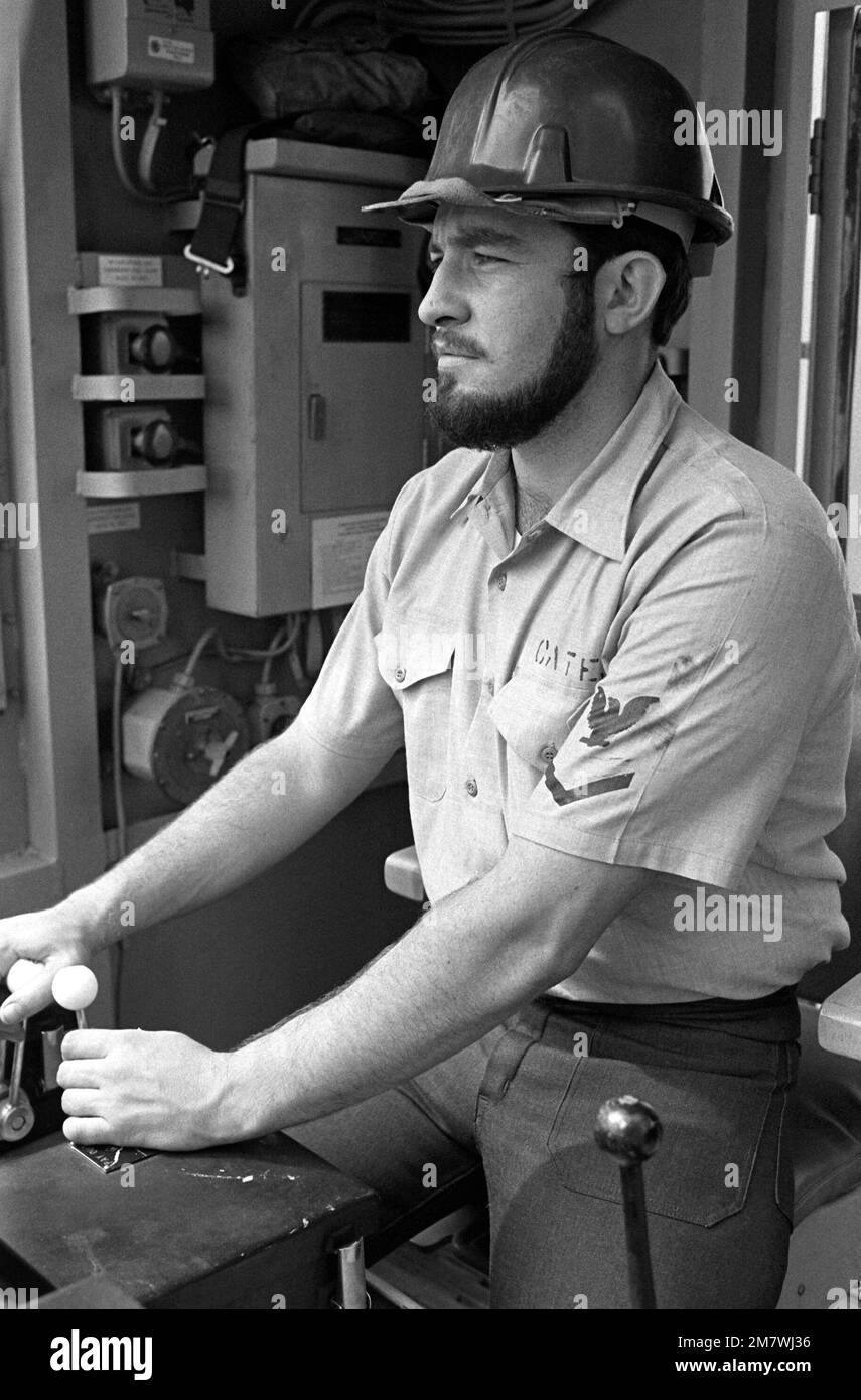 Boatswain's Mate 3rd Class Martin Cates operates a winch at one of the fuelingatsea (FAS