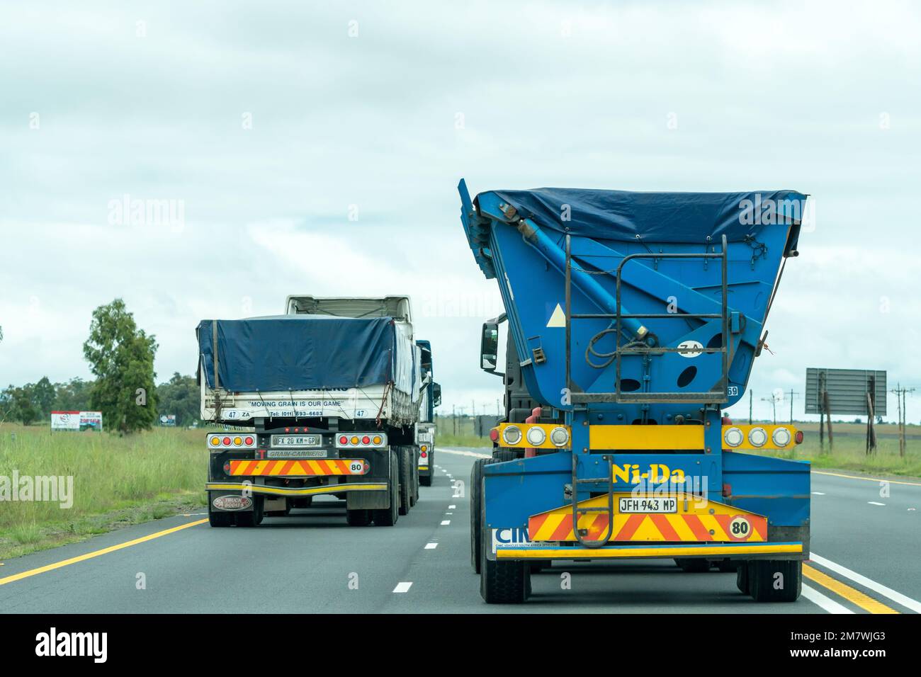 heavy industrial commercial vehicles or trucks on a highway in rural
