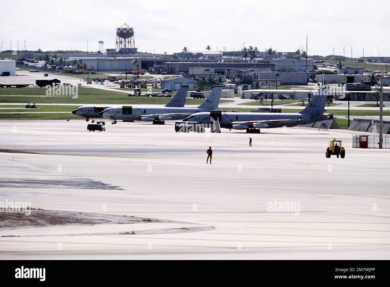 A left side view of KC-135 Stratotanker aircraft parked in line on a ramp with base facilities in the background. The aircraft are assigned to the 43rd Strategic Wing, Pacific Task Force. Base: Andersen Air Base State: Guam (GU) Country: United States Of America (USA) Stock Photo