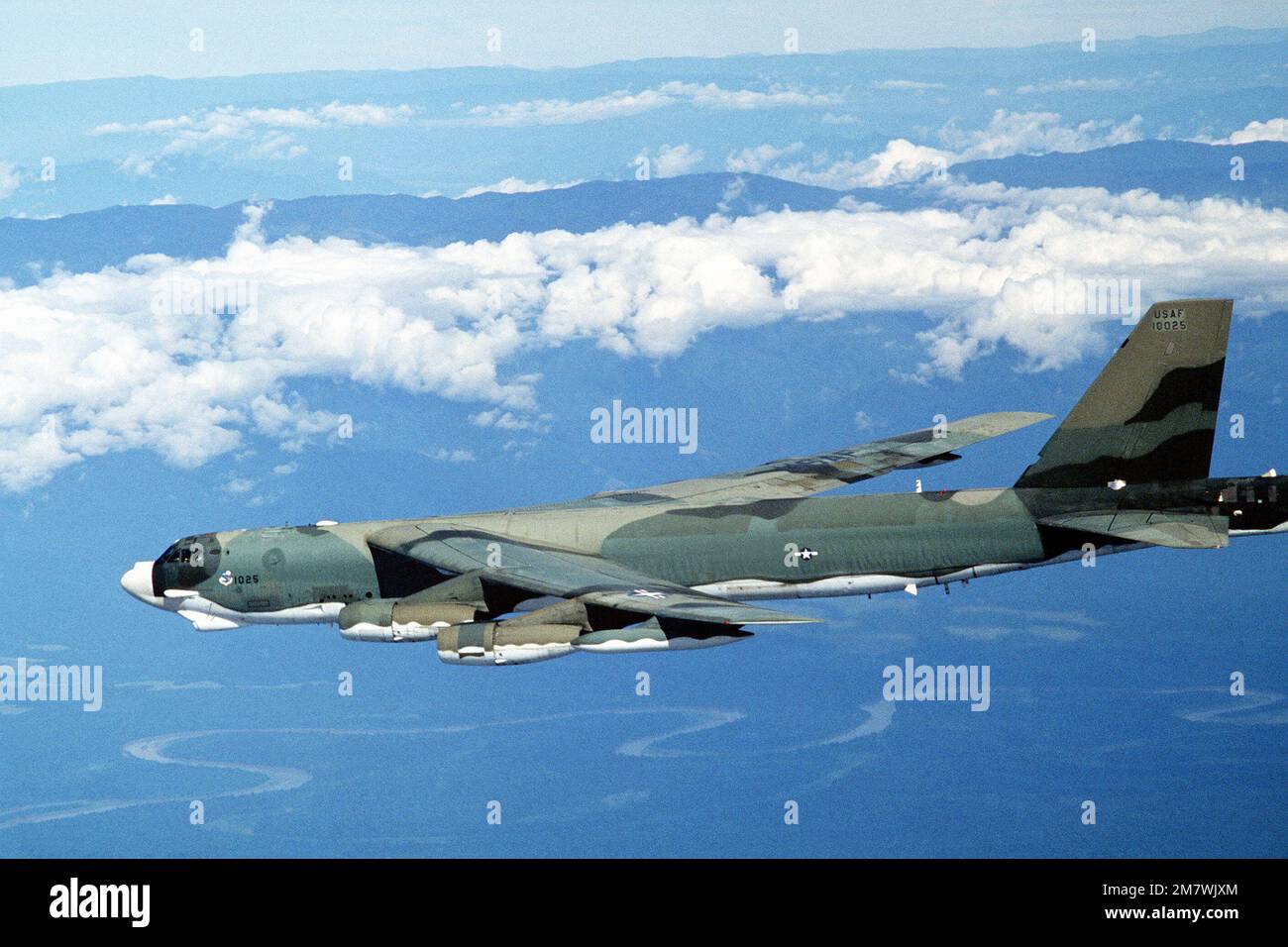 A left side view of a B52H Stratofortress aircraft in flight from Guam