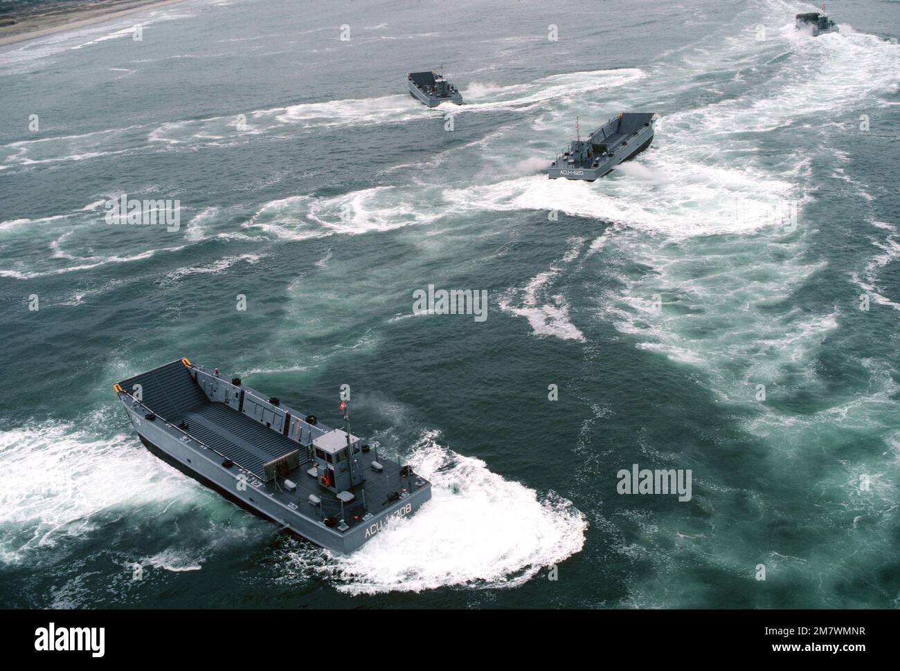 An aerial view of mechanized landing craft performing high speed maneuvers during a practice landing at the Silver Strand area of North Island. The boats are attached to Assault Craft Unit One (ACU-1). Base: San Diego State: California (CA) Country: United States Of America (USA) Stock Photo