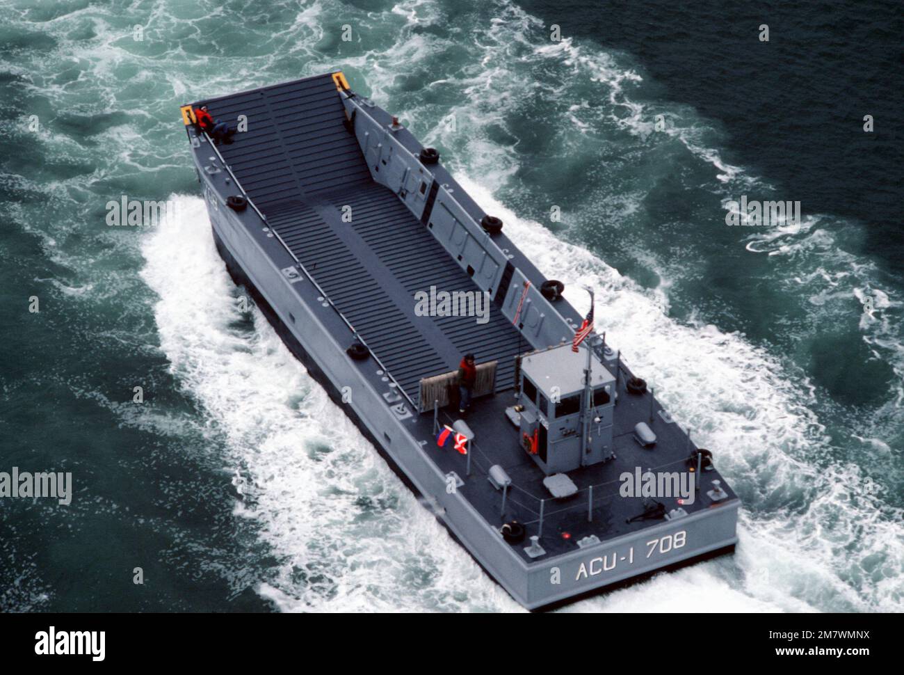 A port quarter view of mechanized landing craft LCM-708 during a practice landing at the Silver Strand area of North Island. The LCM is attached to Assault Craft Unit One (ACU-1). Base: San Diego State: California (CA) Country: United States Of America (USA) Stock Photo