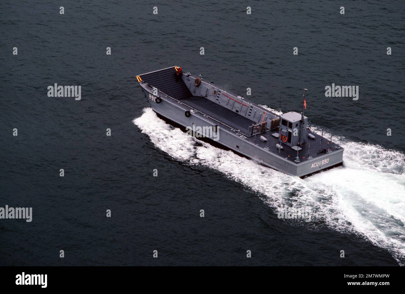 An aerial port quarter view of the mechanized landing craft (LCM-890) attached to Assault Craft Unit One (ACU-1) during a practice landing at the Silver Strand area of North Island. Base: San Diego State: California (CA) Country: United States Of America (USA) Stock Photo