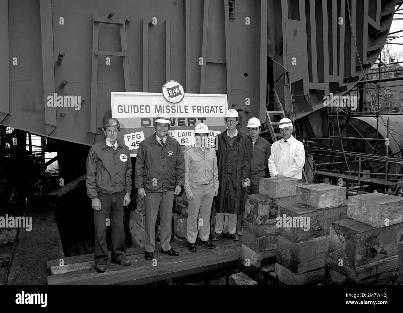 Shipyard and U.S. Navy personnel pose for a photograph during the keel laying of the guided