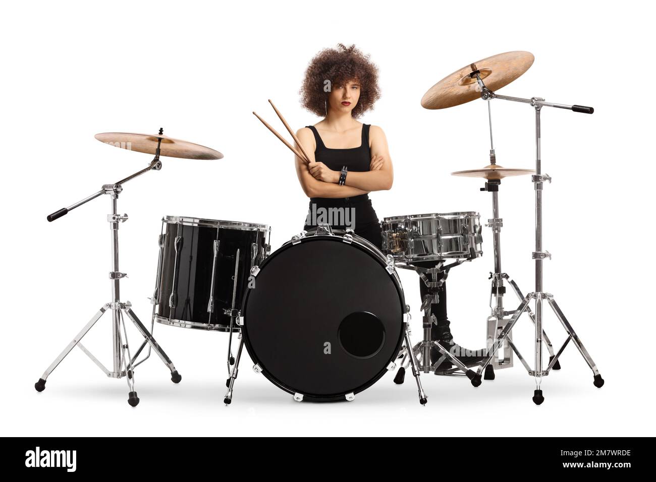 Female drummer sitting and holding drumsticks isolated on white background Stock Photo